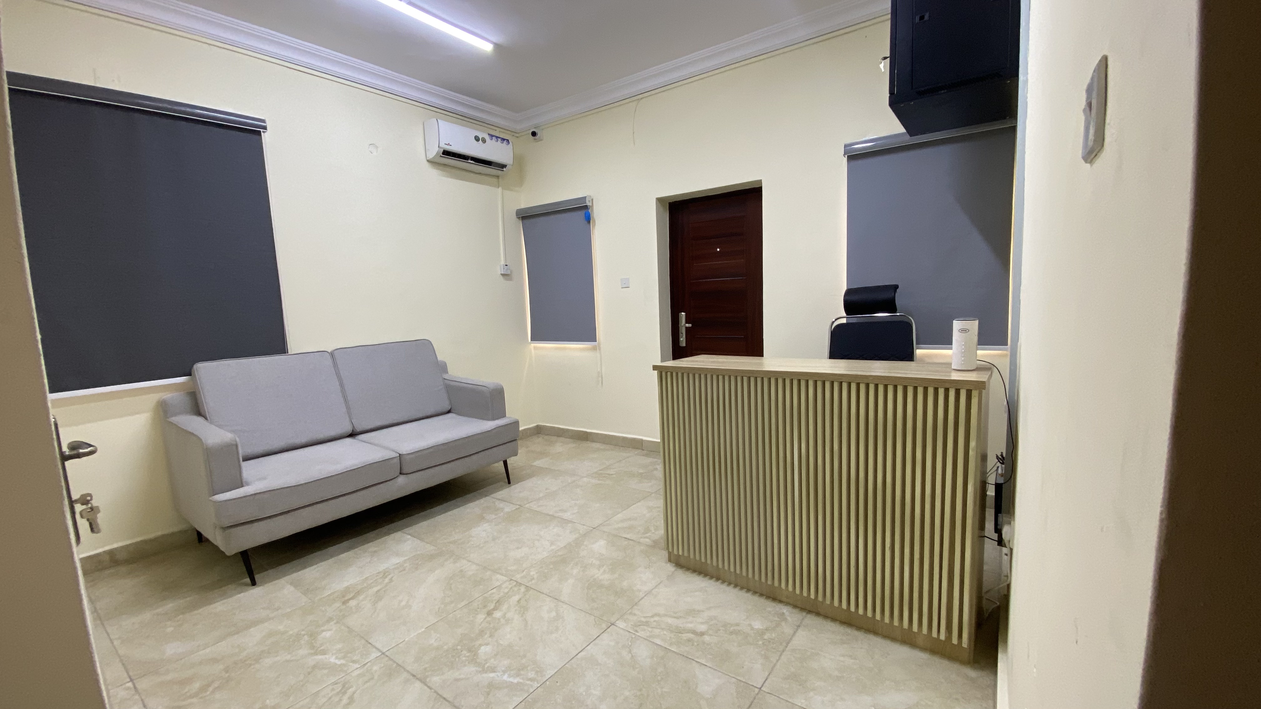 Reception area at Befitting Hub with front desk and sofa seating
