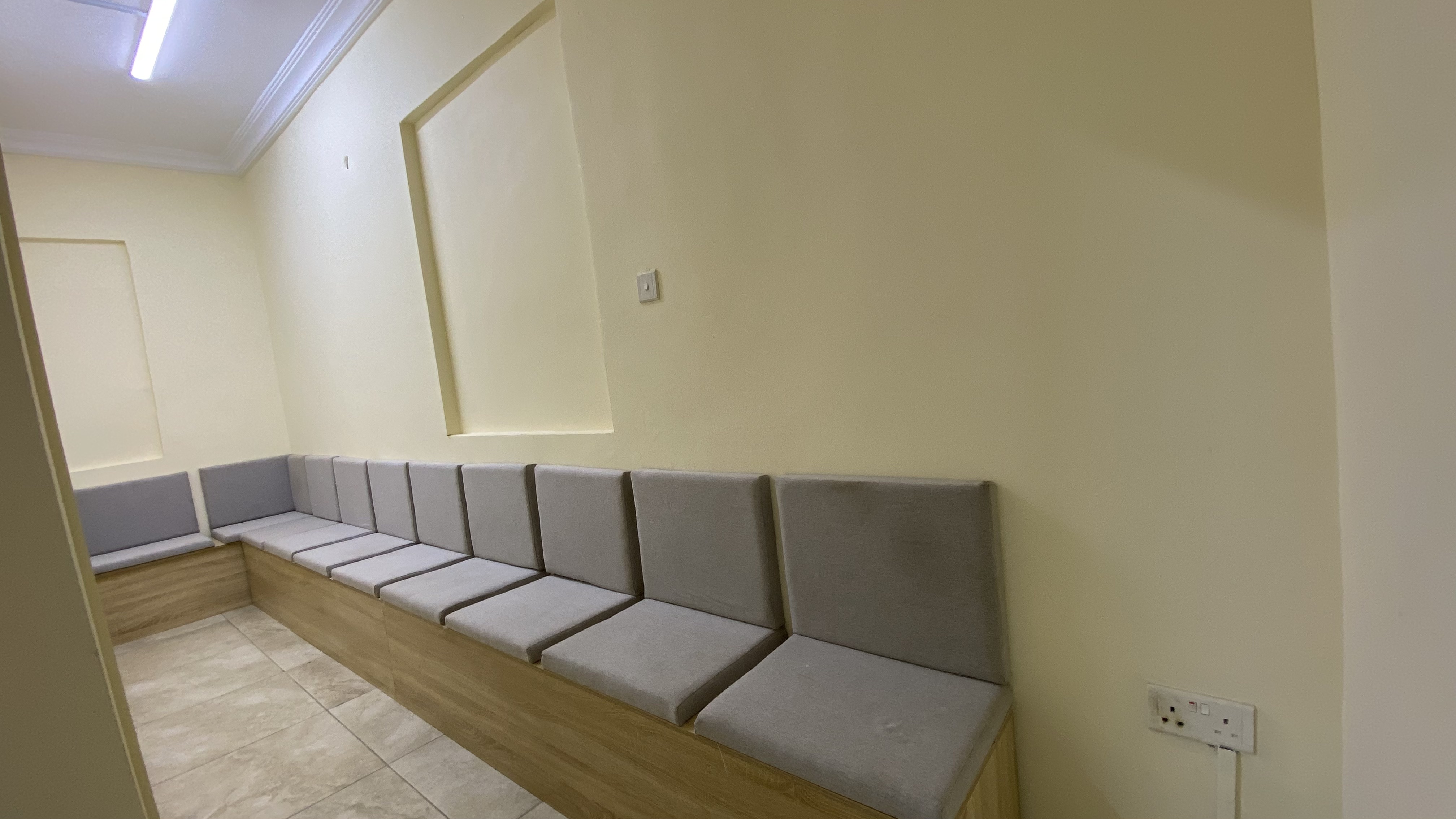 Candidate waiting bench along a bright corridor at Befitting Hub