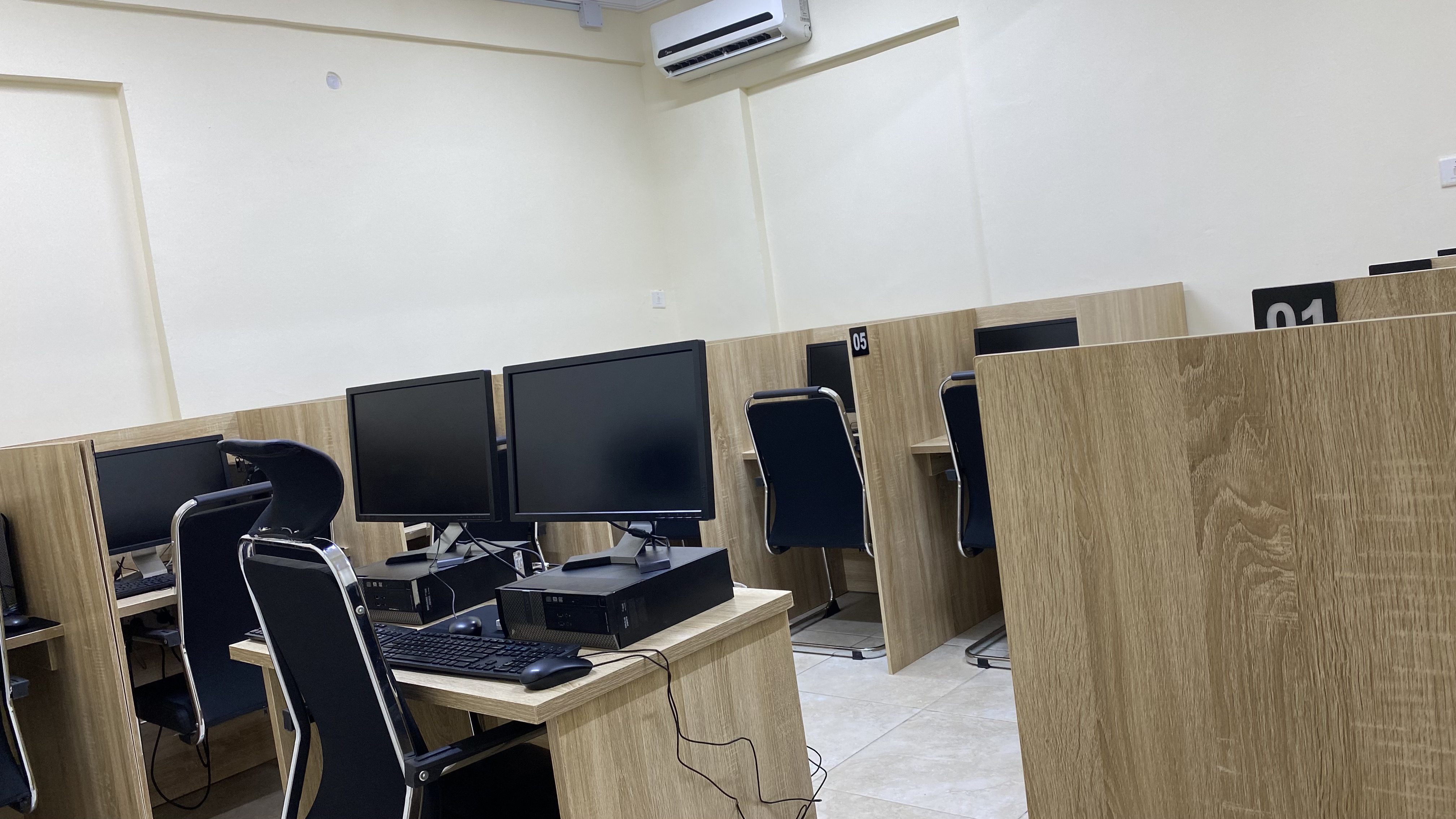 Computer-based testing room at Befitting Hub with individual candidate workstations and dividers